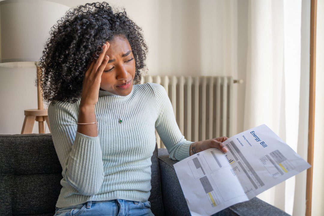 Woman looking at expensive energy bill.