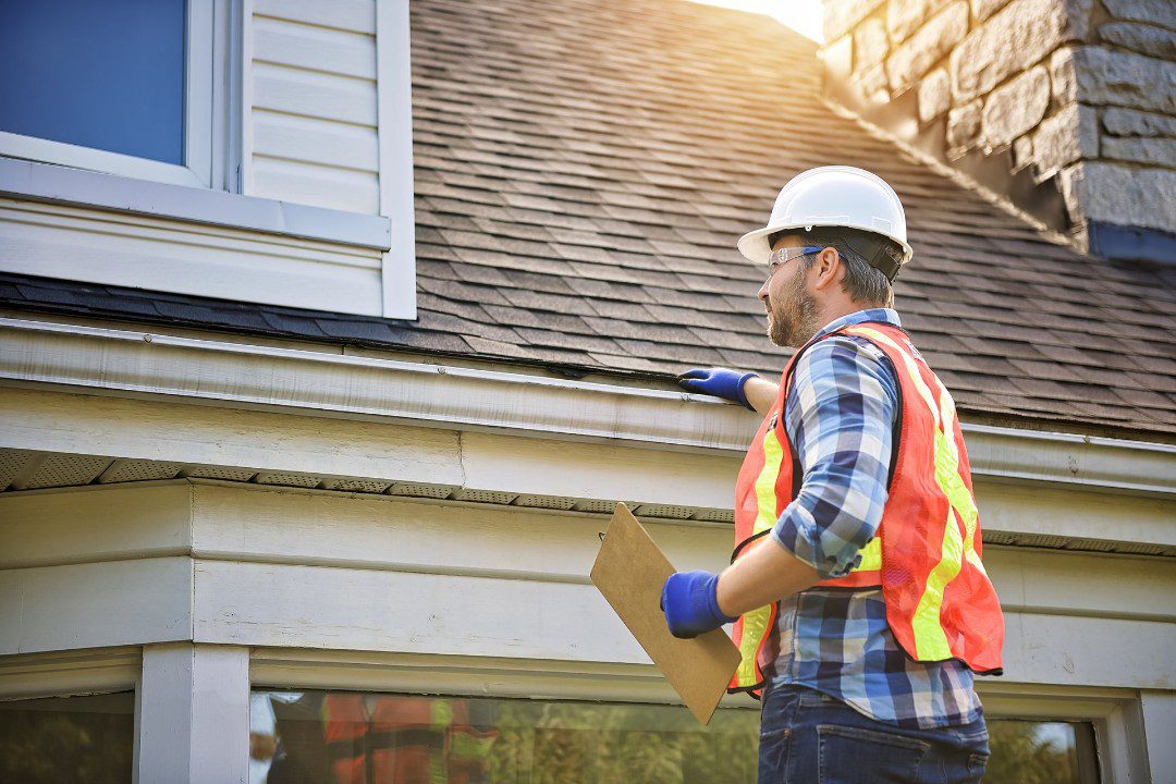 Solar technician inspecting roof before residential installation