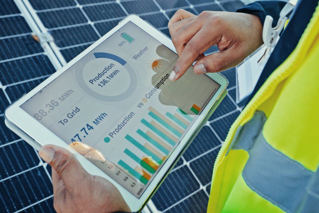 Technician reviewing solar power consumption report